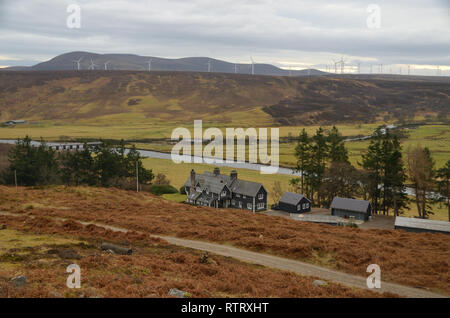 The Lodge at Balnacoil in the valley Strath Brora with Kilbraur windfarm behind, in the county of Sutherland, UK. Stock Photo