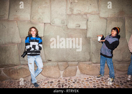 Cusco, Peru, July 2018: People who visit Cusco can not stop taking pictures next to the famous twelve-sided stone found in one of the walls of the anc Stock Photo