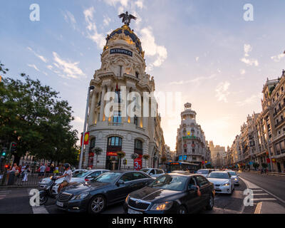 Cars waiting for traffic-light at the street cross Calle de Alcala and Gran Via at sunny evening in Madrid, Spain Stock Photo