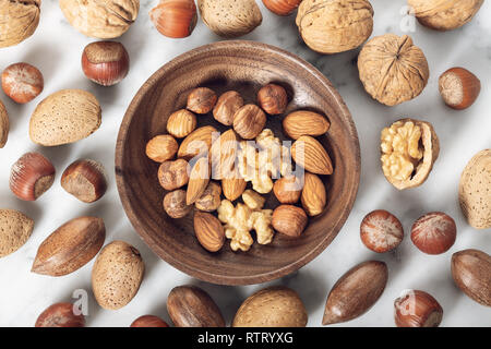 Nuts Mixed in a wooden plate.Assortment, Walnuts,Pecan,Almonds,Hazelnuts. Healthy appetizer Stock Photo