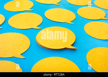 Yellow chat,speech bubble icons on blue color background.Talking and  message for social media concepts ideas Stock Photo