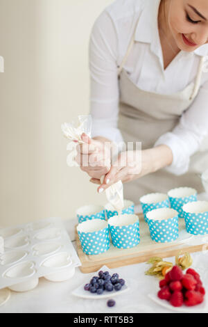 young Asian woman following the recipe. close up cropped photo. Stock Photo