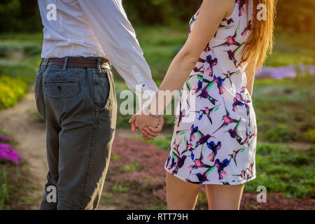 Couple in love holds hands in spring garden Stock Photo