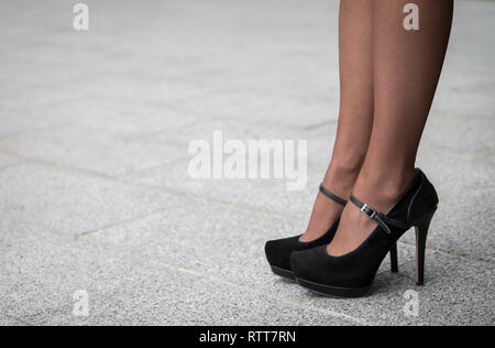 Woman wearing a pair of black classic high heels outdoor Stock Photo