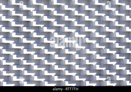 White brick wall in unusual pattern with bricks sticking out Stock Photo