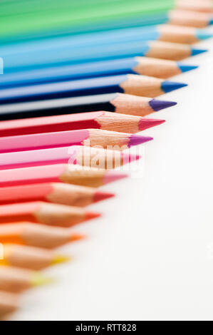 Low angle close-up of parallel horizontal cursors rising up to the right on white background with focus on the red pins in the upper image center. Stock Photo