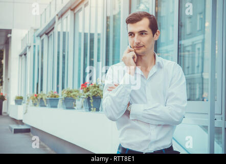 Young buisnessman talking on the phone by business center Stock Photo