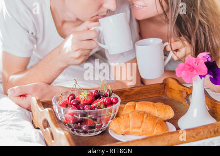 Couple in love having breakfast in bed Stock Photo