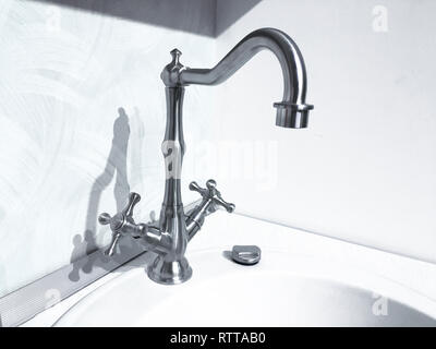 Vintage retro brass water tap faucet closeup on light background Stock Photo