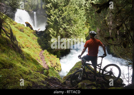 Mountain Biker at Sahalie Falls on the McKenzie River Trail Near Eugene Oregon Stock Photo
