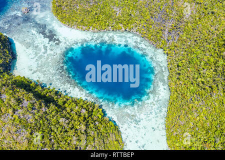 aerial view of a remote island with a shallow blue hole, Raja Ampat Islands, West Papua, Indonesia, Pacific Ocean Stock Photo