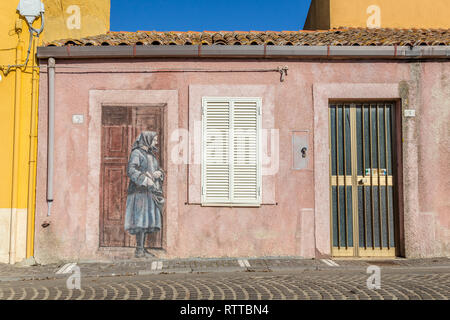 Sardinia Italy on December 27, 2019: Murals painted on houses in the streets of Tinnura depicting moments of rural and village life Stock Photo