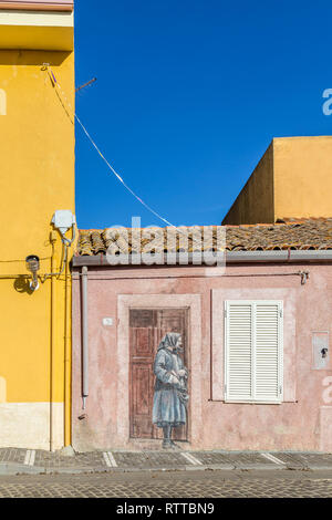 Sardinia Italy on December 27, 2019: Murals painted on houses in the streets of Tinnura depicting moments of rural and village life Stock Photo