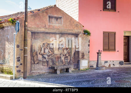 Sardinia Italy on December 27, 2019: Murals painted on houses in the streets of Tinnura depicting moments of rural and village life Stock Photo