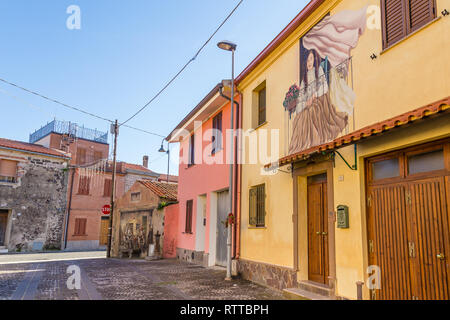 Sardinia Italy on December 27, 2019: Murals painted on houses in the streets of Tinnura depicting moments of rural and village life Stock Photo