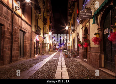 Bosa, Sardinia island Italy - December 29, 2019: Tourist relaxing during the evening in the ancient streets of Bosa, Sardinia Island, Italy Stock Photo