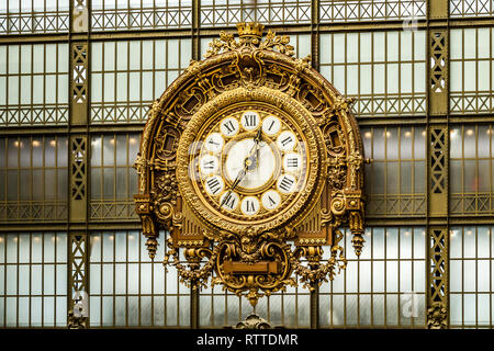 A large Gold wall clock hanging on the wall at Musée d'Orsay ,a famous Parisian Art museum in Paris, France Stock Photo