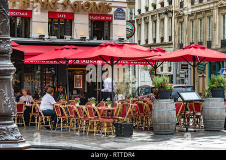 People sitting at tables outside À la Place Saint-Georges, a cafe restaurant in St Georges, in the 9th Arrondissement of Paris, France Stock Photo