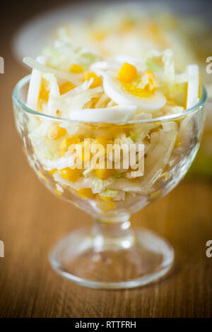 Fresh Peking cabbage salad with boiled eggs, canned corn