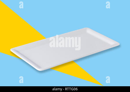 Empty white cornered plate on blue yellow popart background, front view, oblique position Stock Photo