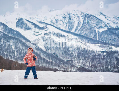 little girl in winter in the mountains Stock Photo