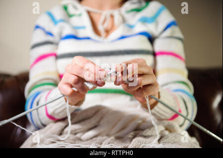 Women's hands knitting. Close up of hands knitting. Process of knitting Stock Photo