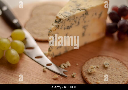 Cheese grapes and biscuits on a cheese board Stock Photo