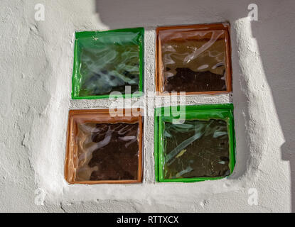 Glass window blocks in white washed wall Stock Photo