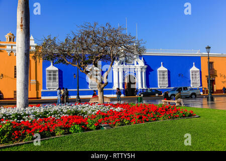 Trujillo, Peru, July 2018: Colored buildings next to the cathedral, in the city's main square, bathed in the light of sunset Stock Photo