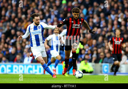 Huddersfield Town's Philip Billing (right) and Brighton & Hove Albion's Davy Propper (left) during the Premier League match at the AMEX Stadium, Brighton.