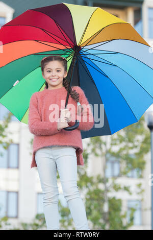 Girl child long hair with umbrella. Colorful accessory positive influence. Bright umbrella. Stay positive and optimistic. Everything better with my umbrella. Colorful accessory for cheerful mood. Stock Photo