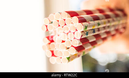 Bunch of red and white striped paper straws with some with stars on Stock Photo
