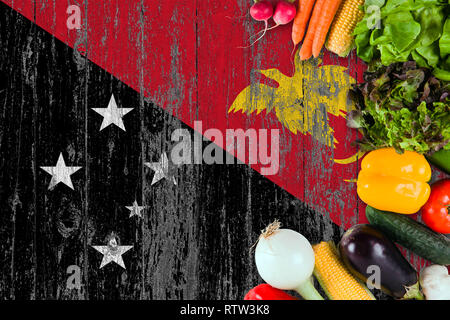 Fresh vegetables from Papua New Guinea on table. Cooking concept on wooden flag background. Stock Photo