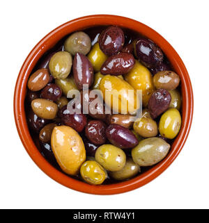 green and purple, mixed olives in clay bowl - isolated on white background Stock Photo