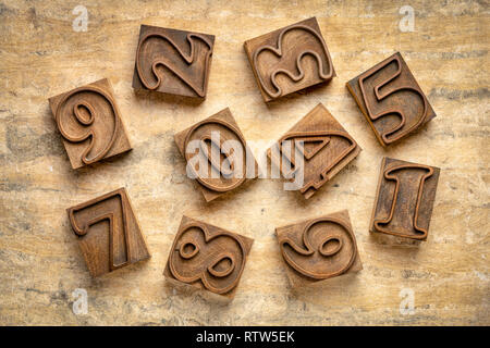 numbers in letterpress wood type (outlined font) against textured bark paper Stock Photo