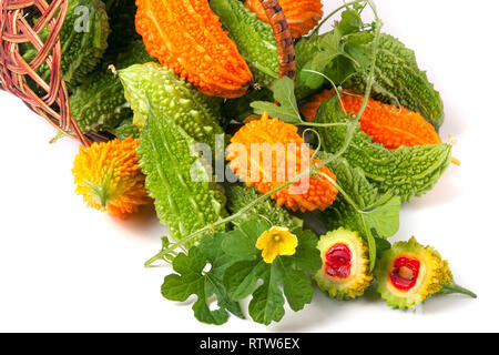 bitter melon or momordica in a wicker basket isolated on white background Stock Photo