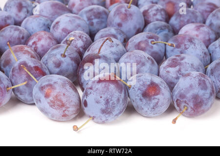 heap of blue plums isolated on a white background Stock Photo