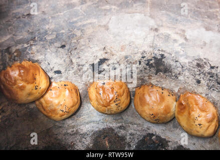 Process of cooking samsa in tandoor in Crimea Stock Photo