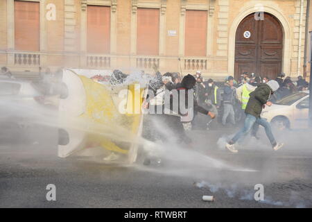 Toulouse, France. 2nd March 2019. The weekly serious clashes occured once more time on March the 2nd 2019  in the streets of Toulouse, France, between riot police units and the yellow vest (gilets jaunes). Police largely used tear gas. The police water cannon truck disperses the protesters. Credit: Corentin LE GALL/Alamy Live News Stock Photo