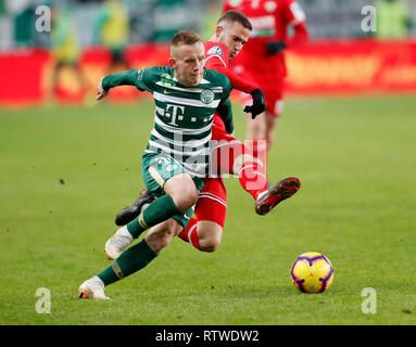 Ivan Petryak of MOL Fehervar FC dribbles between Franck Boli of