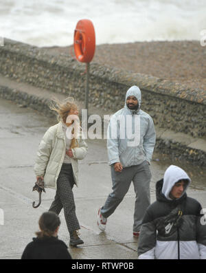 Brighton, East Sussex, UK. 3rd March 2019 .Visitors were determined to enjoy a walk on Brighton seafront today as Storm Freya arrived and started to batter parts of Britain today Credit: Simon Dack/Alamy Live News Stock Photo