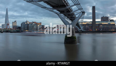 Millennium bridge in evening cityscape London area with riverside panorama. Stock Photo