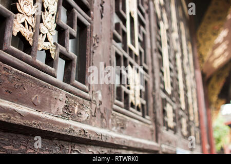 Oriental Wooden Window's Frame. Chinese Golden Pattern on Window's Shutters. Stock Photo