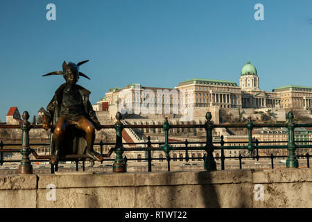 Little Princess statue in Budapest, Hungary. Buca Castle in the distance. Stock Photo