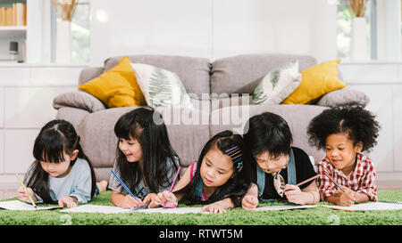 Group of five multi-ethnic young cute preschool kids, boy and girls happy studying or drawing together at home or school. Children education concept Stock Photo