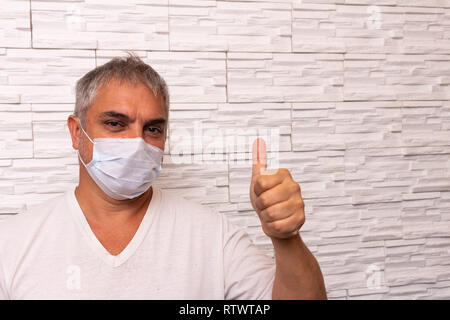 Gray-haired man with chinstrap. Hospital environment. Concept of transplant and contagious diseases or with problems of immunity. Patient looking at c Stock Photo