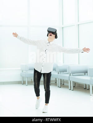 in full growth.a delighted developer is testing virtual reality glasses. Stock Photo