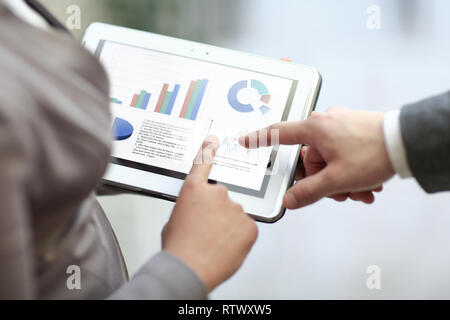 close up. colleagues discuss financial data using a digital tablet Stock Photo