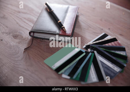 credit cards, Notepad and pen on wooden background Stock Photo