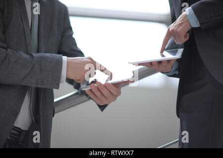 close up. two businessmen with tablet computers Stock Photo